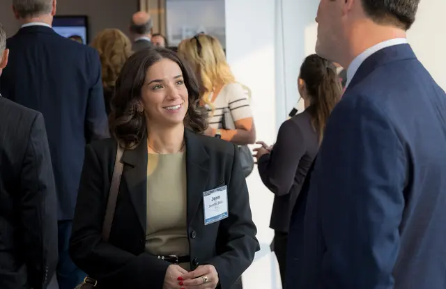 Attendees networking and talking at an ELFA event.